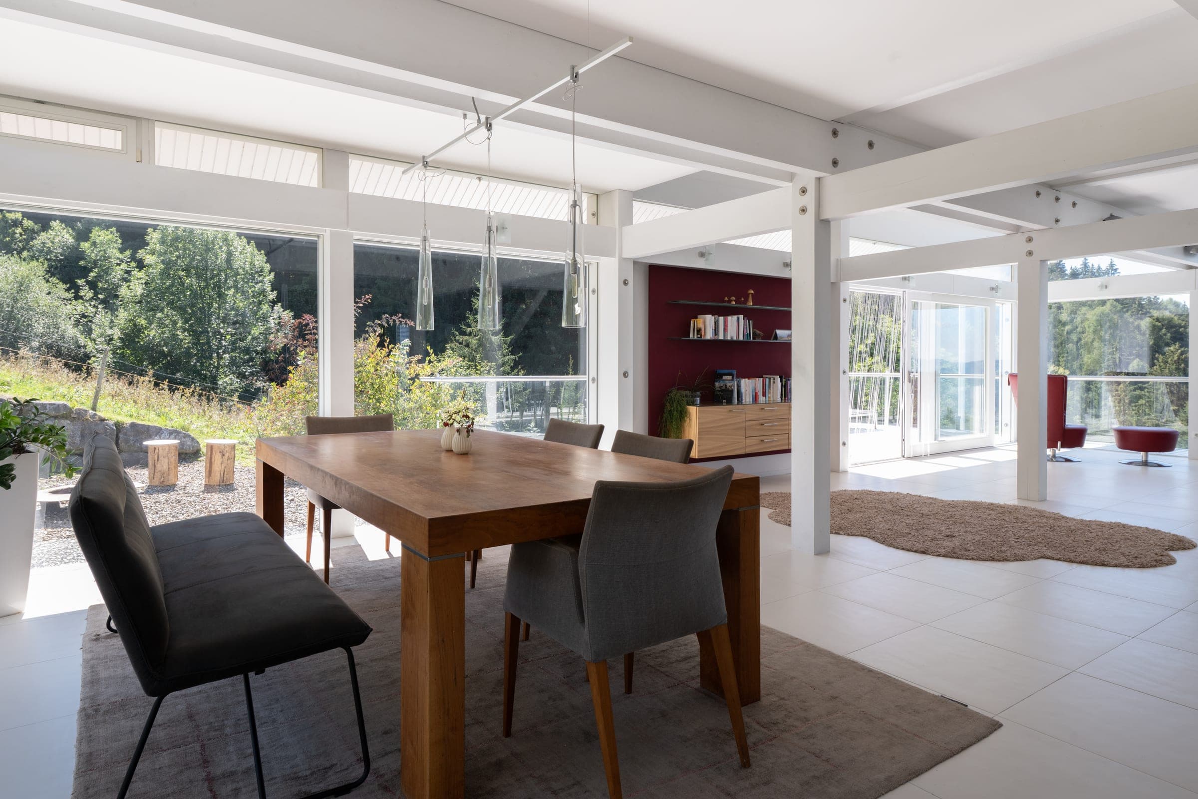 Dining table in the open living room, doors to the terrace