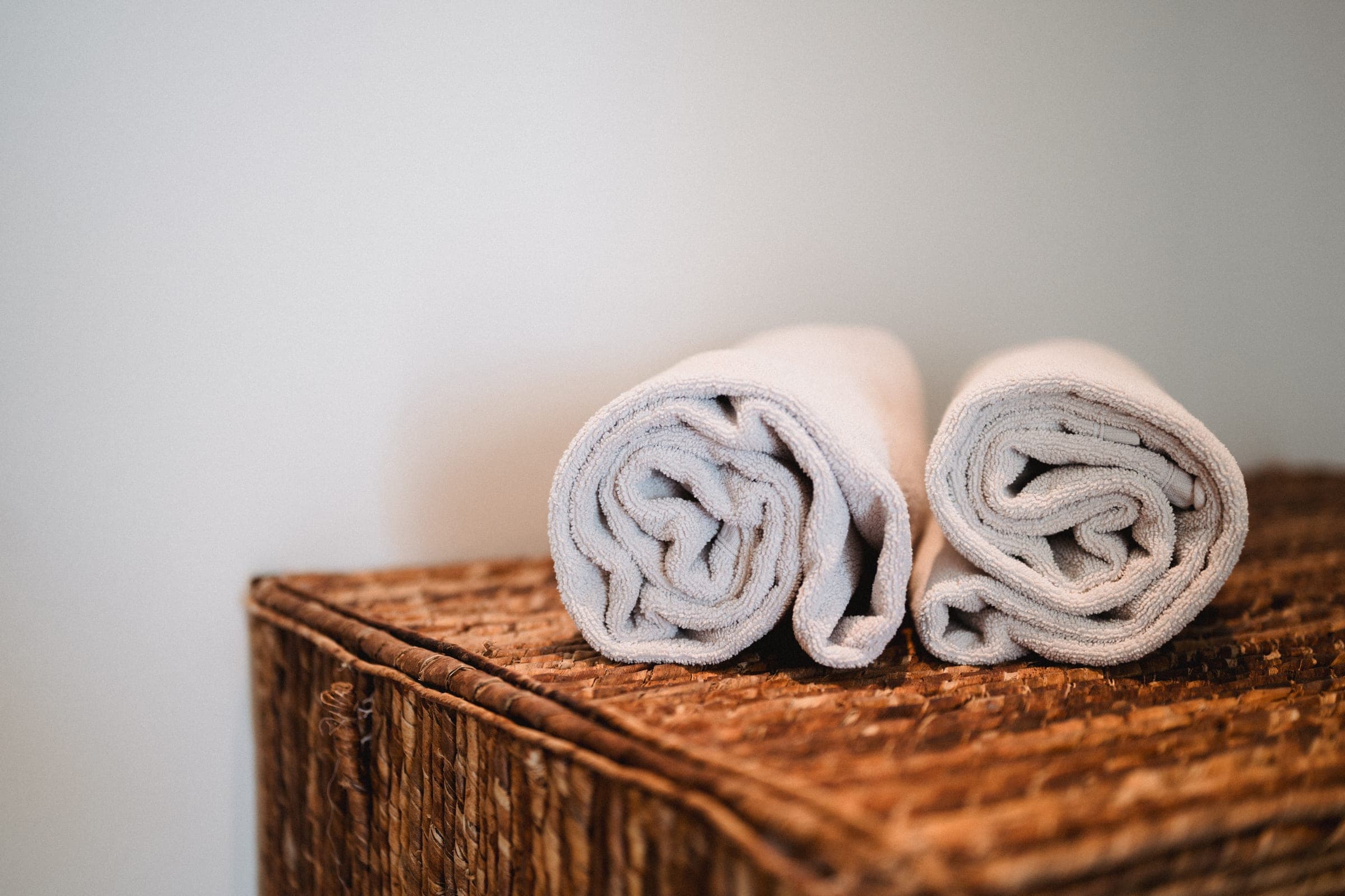 Rolled towels on a wicker chest
