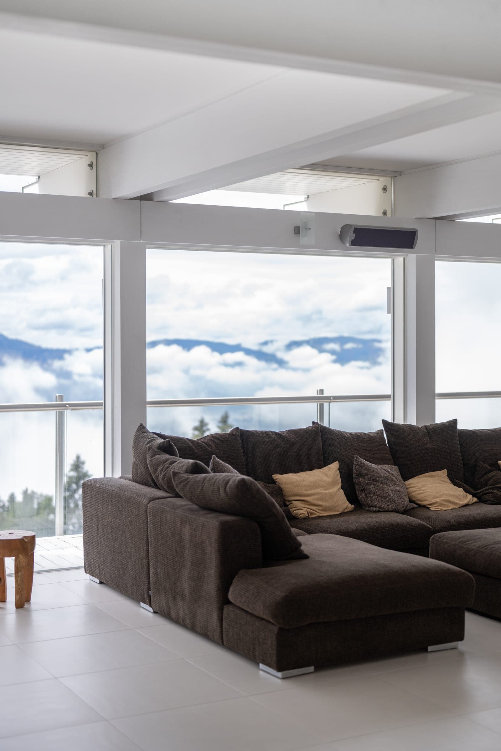 Living room with a window front above the sea of clouds